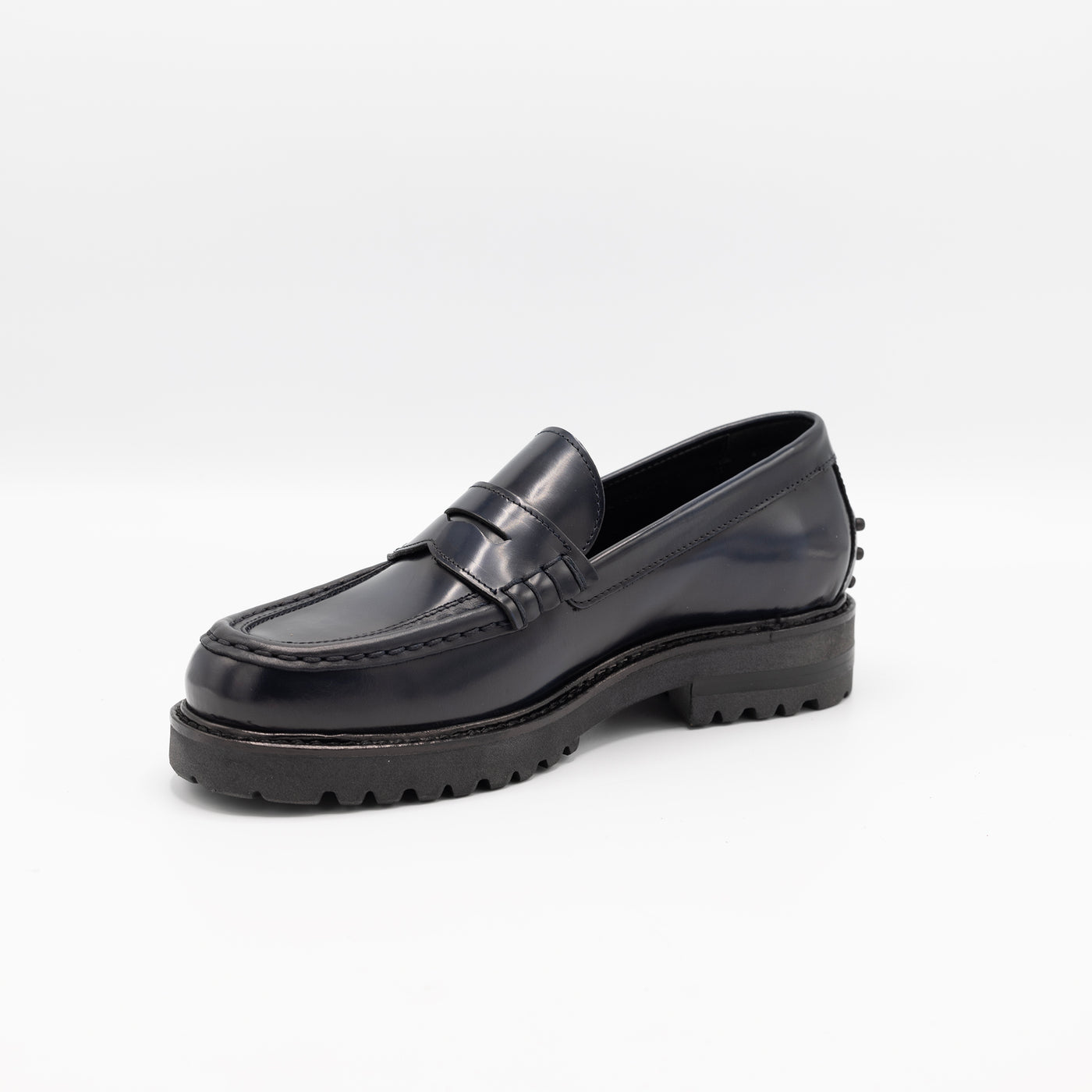 Chunky loafers in glossy dark blue with rubber pebbles on the heel. 