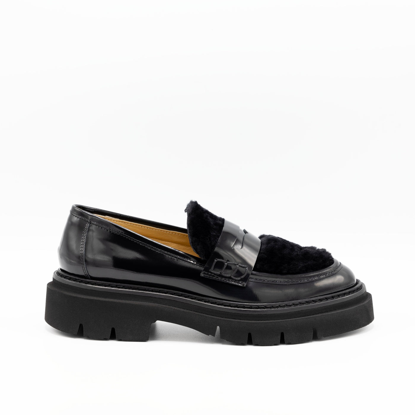 Black leather loafers with shearling uppers.