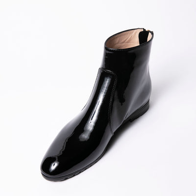 Glossy black ankle boots with round toe. 