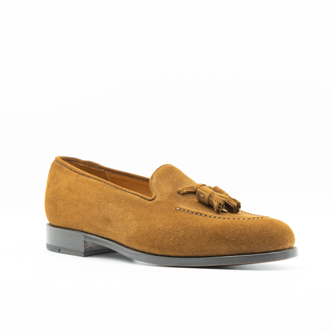 Men's tassel loafer in cognac suede. Set on leather soles with goodyear welted construction. 
