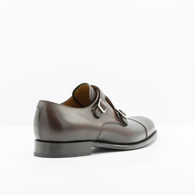 Double monk strap shoes in deep brown leather. Set on leather good year welted soles. Cap toe.