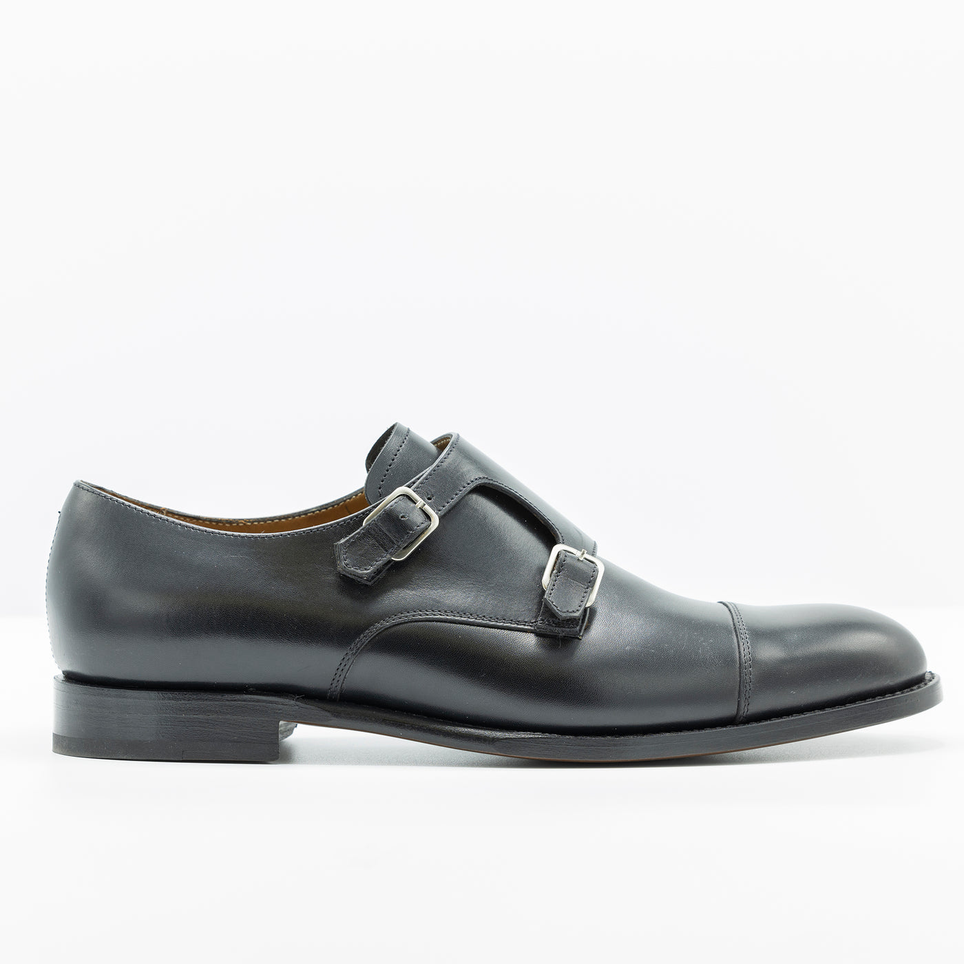 Black leather double monk strap. good year welt leather soles cap toe.