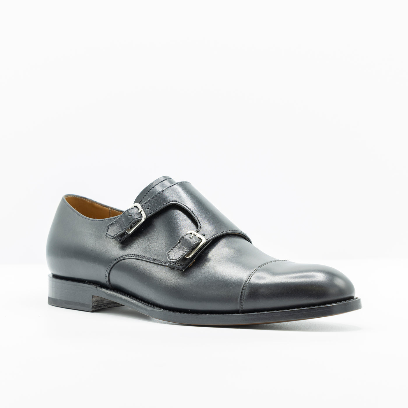 Black leather double monk strap. good year welt leather soles cap toe.