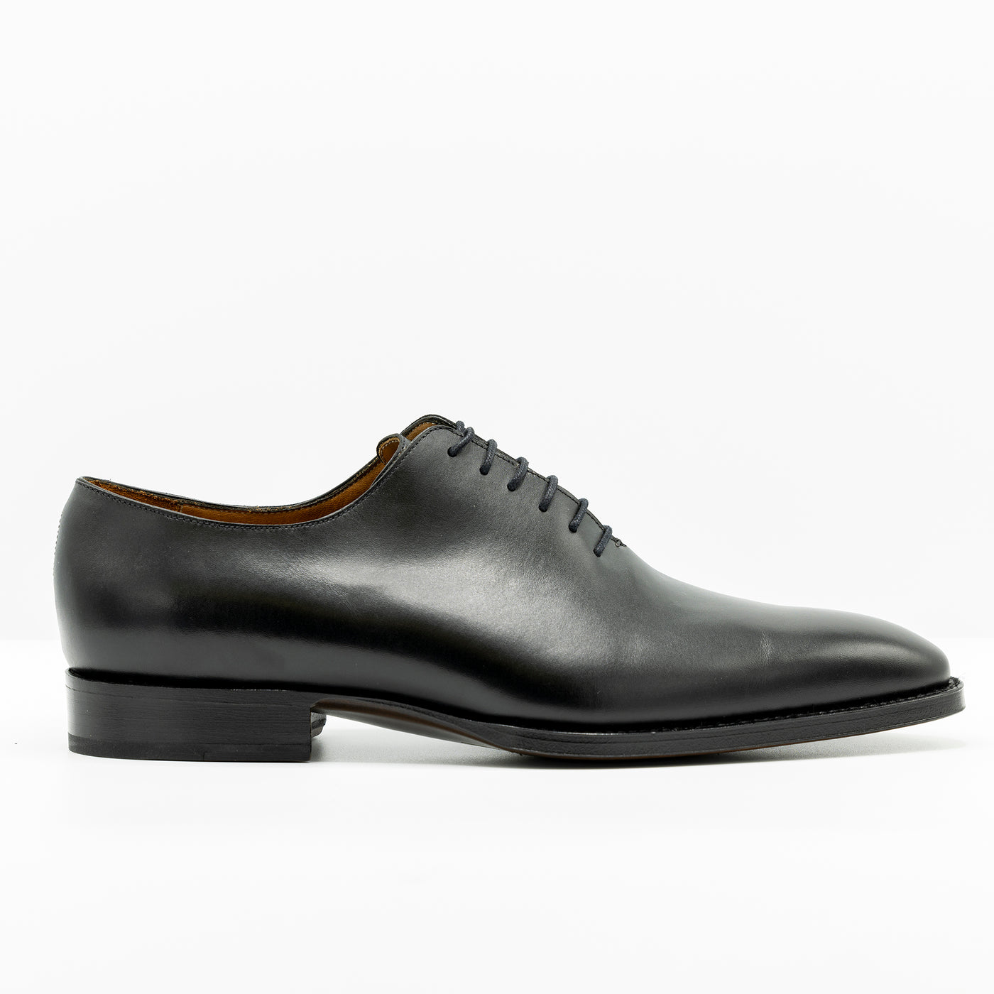Black Leather oxfords with closed lacing and set on handstiched good year welted soles. 