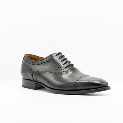 Black leather oxford shoes set on goodyear welted leather soles.Waxed shoe laces. 