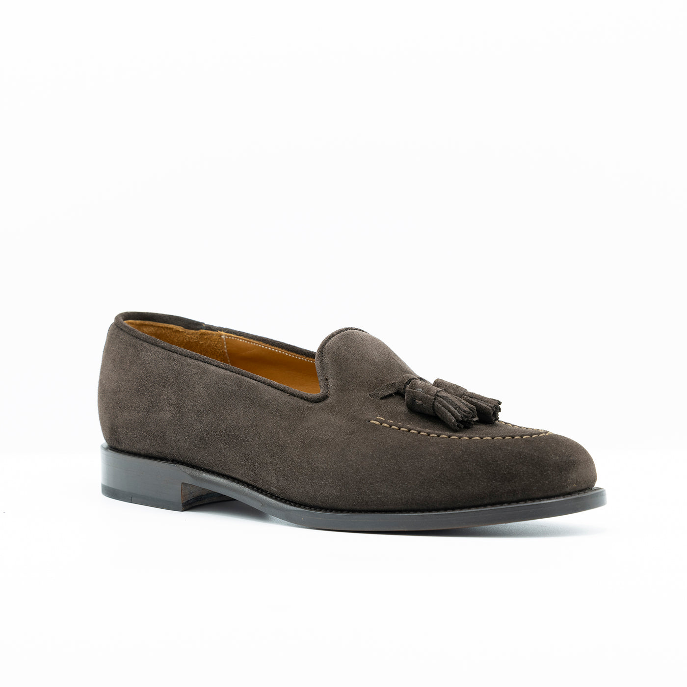 Deep brown tassel loafer set on edgestitched leather soles.