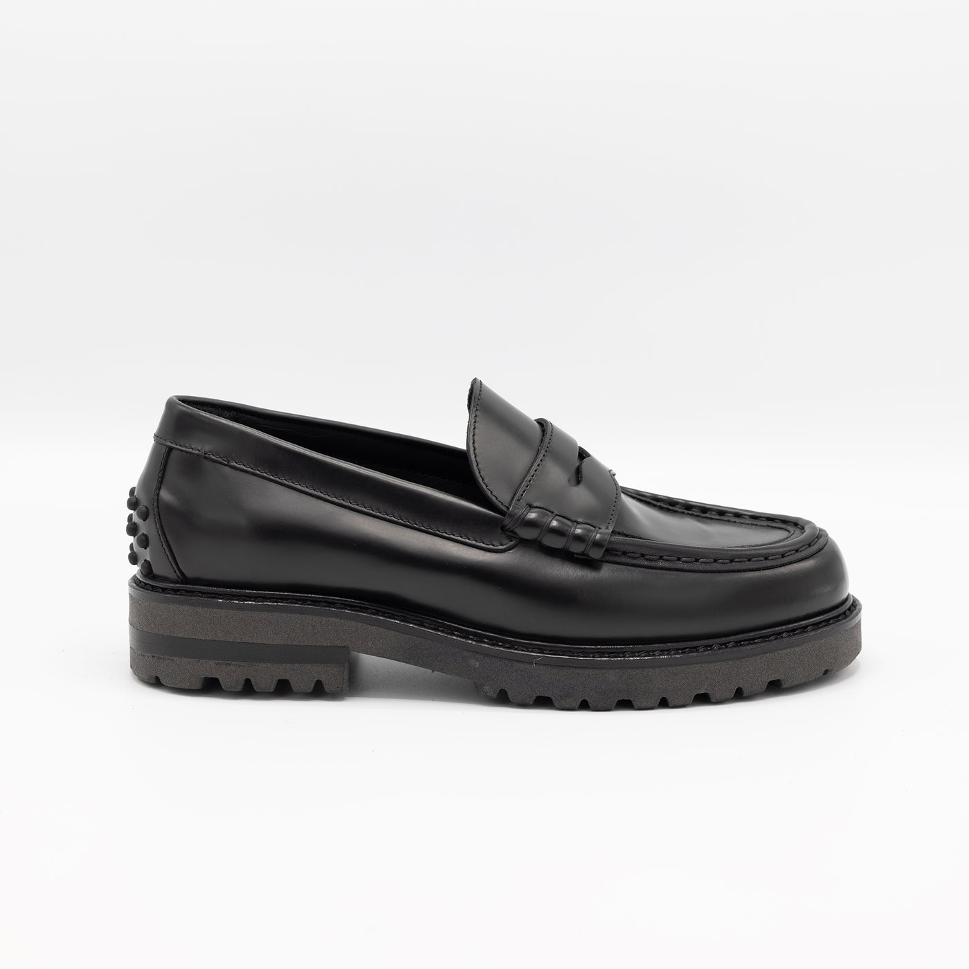 Black patent chunky loafer with rubber pebbles on heel.