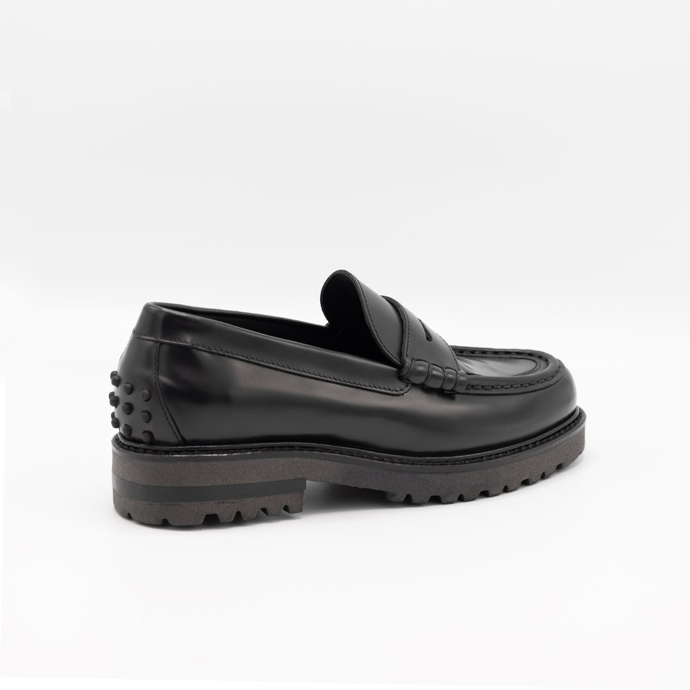 glossy black leather loafers with chunky sole and rubber pebbles. 