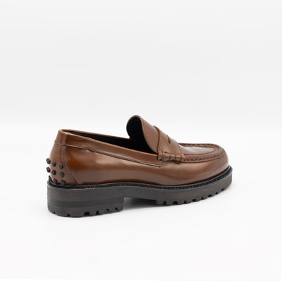 Chunky leather loafers in glossy cognac leather and rubber pebble on heel. 
