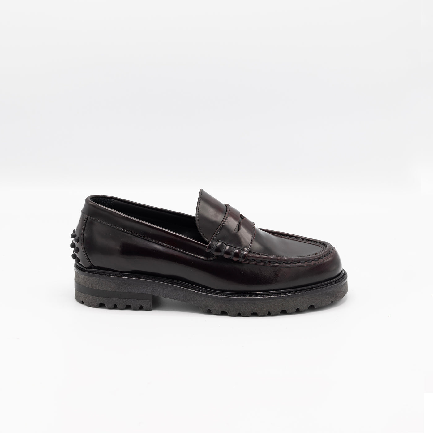 Chunky loafer in glossy burgundy leather with rubber pebbles on the heel. 