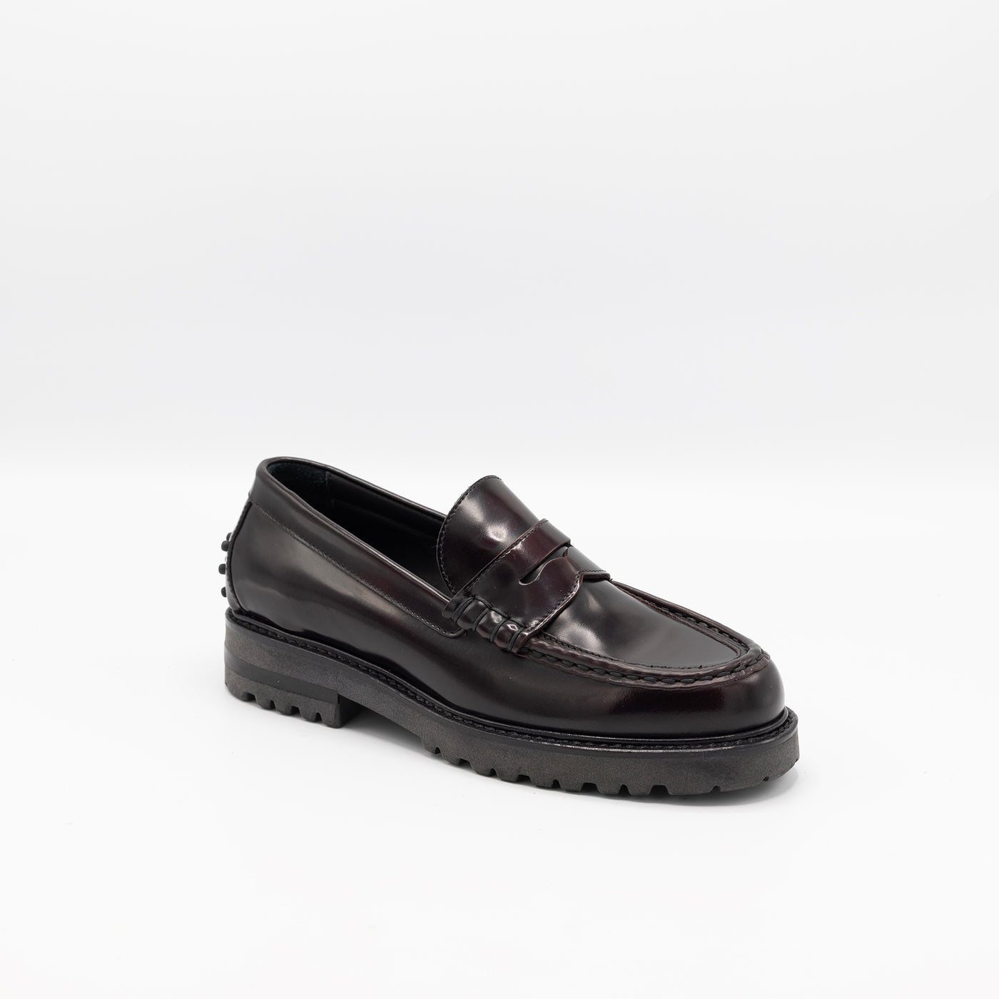 Glossy patent leather loagers with rubber pebbles on heel. 