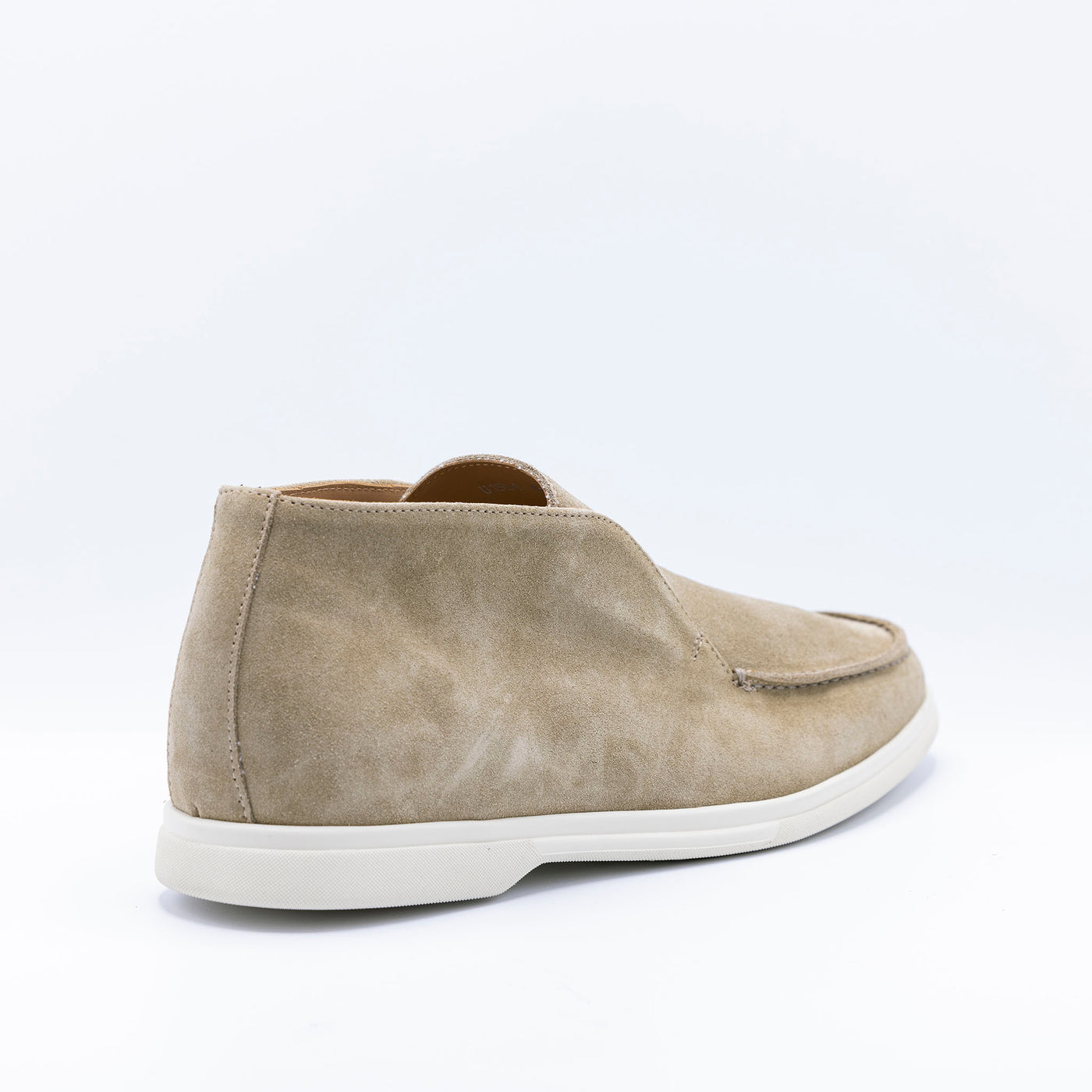 Open walks in beige suede set on white rubber soles. 