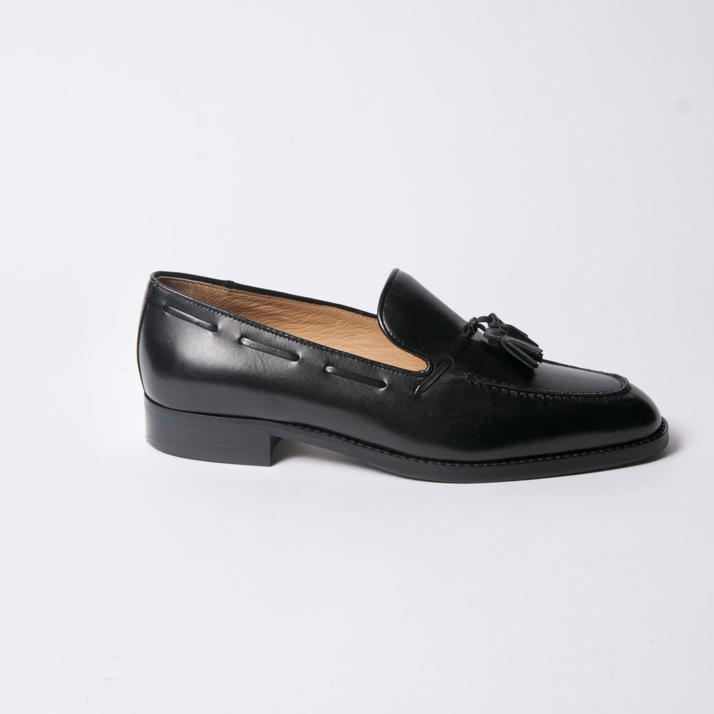 Black Leather tassel loafer set on an extra light rubber sole. 
