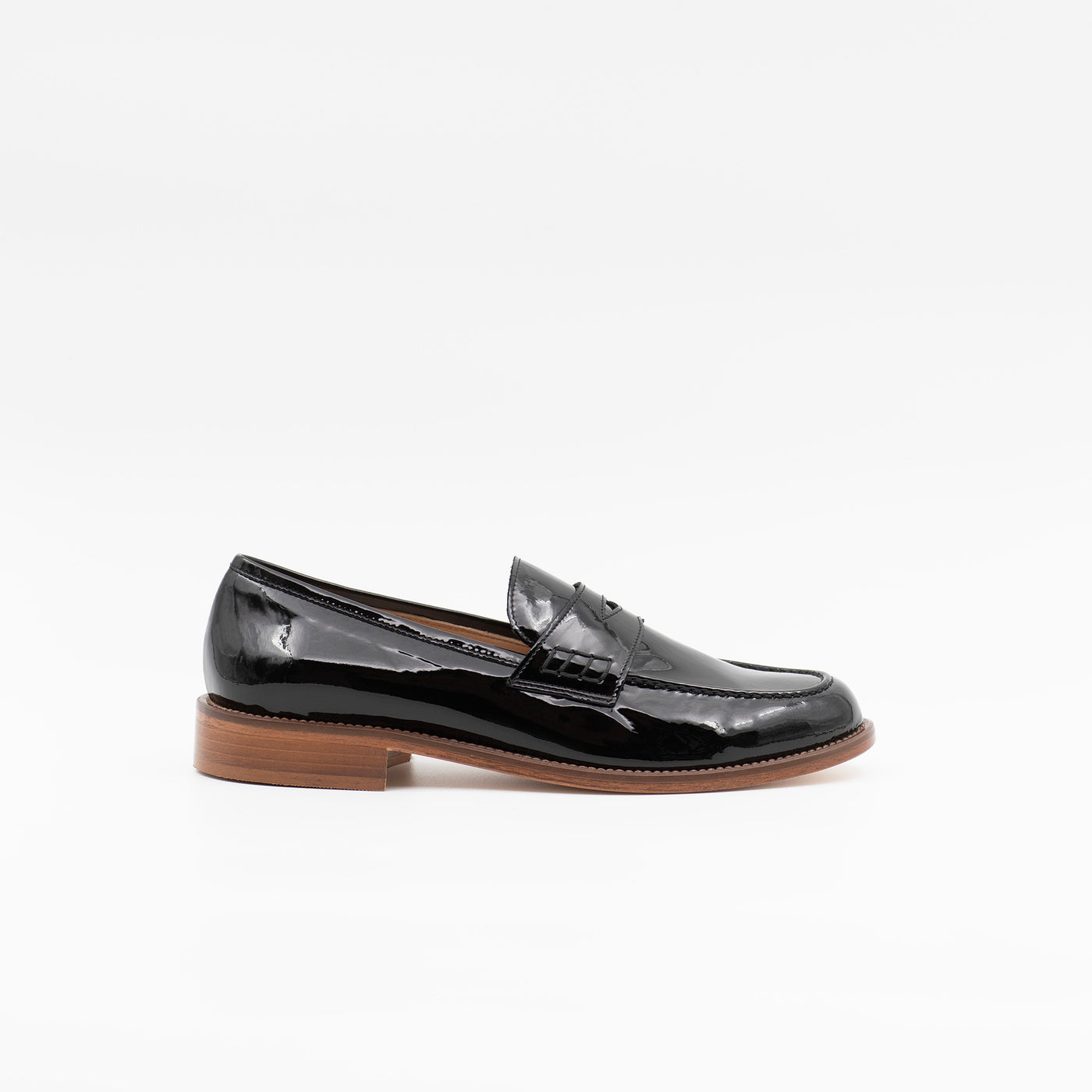 Black patent loafer with brown sole