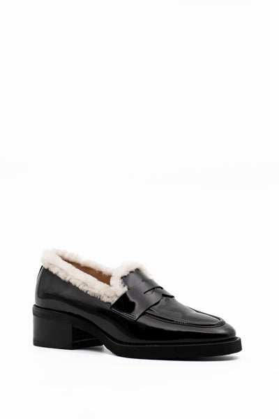 Black loafer with contrasting white fur trim