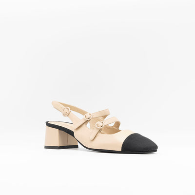 Beige leather pumps with contrasting rips toe with double straps. 