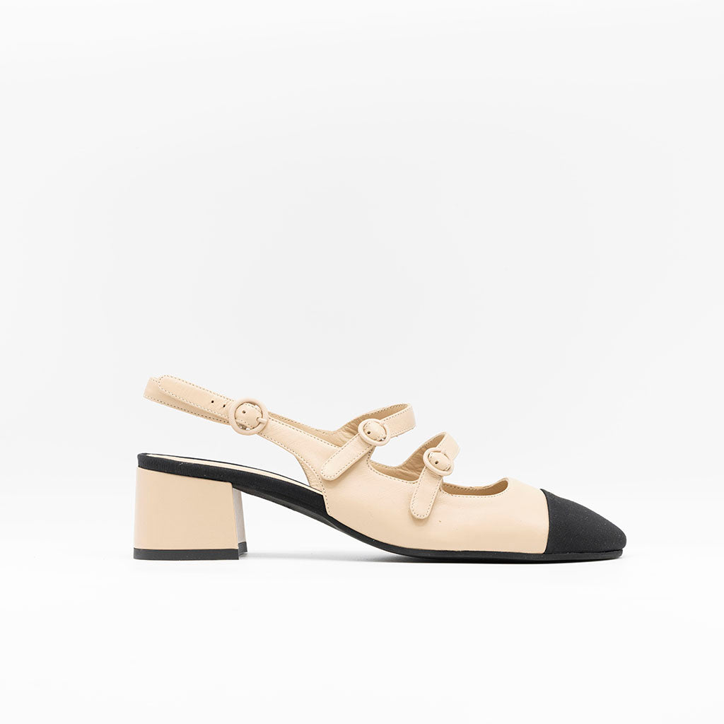 Beige leather pumps with Mary Jane strap. 