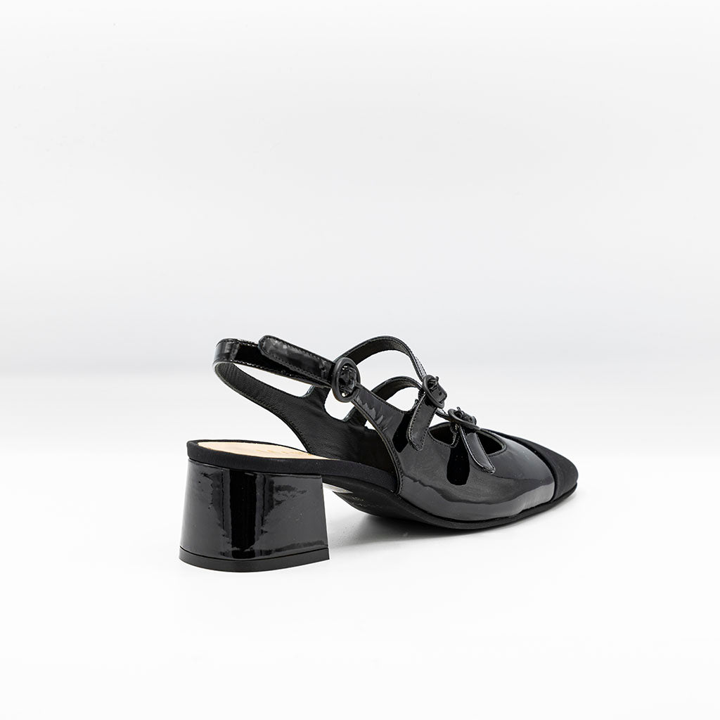 Glossy black patent pumps with slingback heel and mary jane strap. 