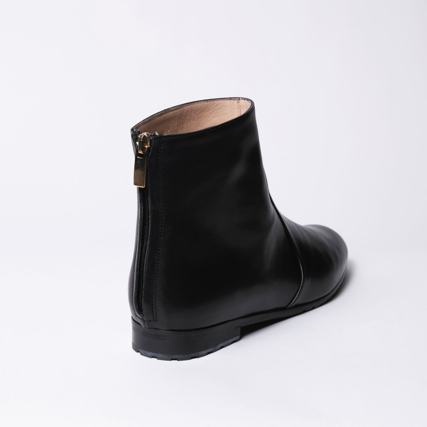 Black leather ankle boots with zipper in the back. 