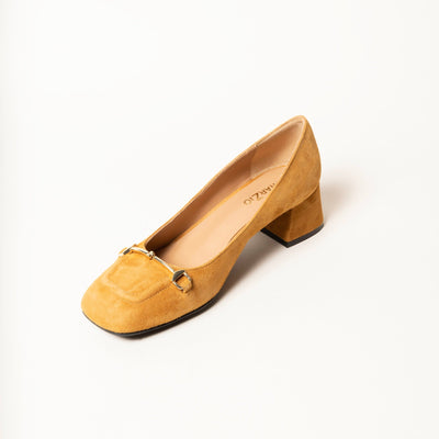 Heeled pump made from soft suede leather, featuring a square-shaped toe with a gold metallic horse-bit buckle