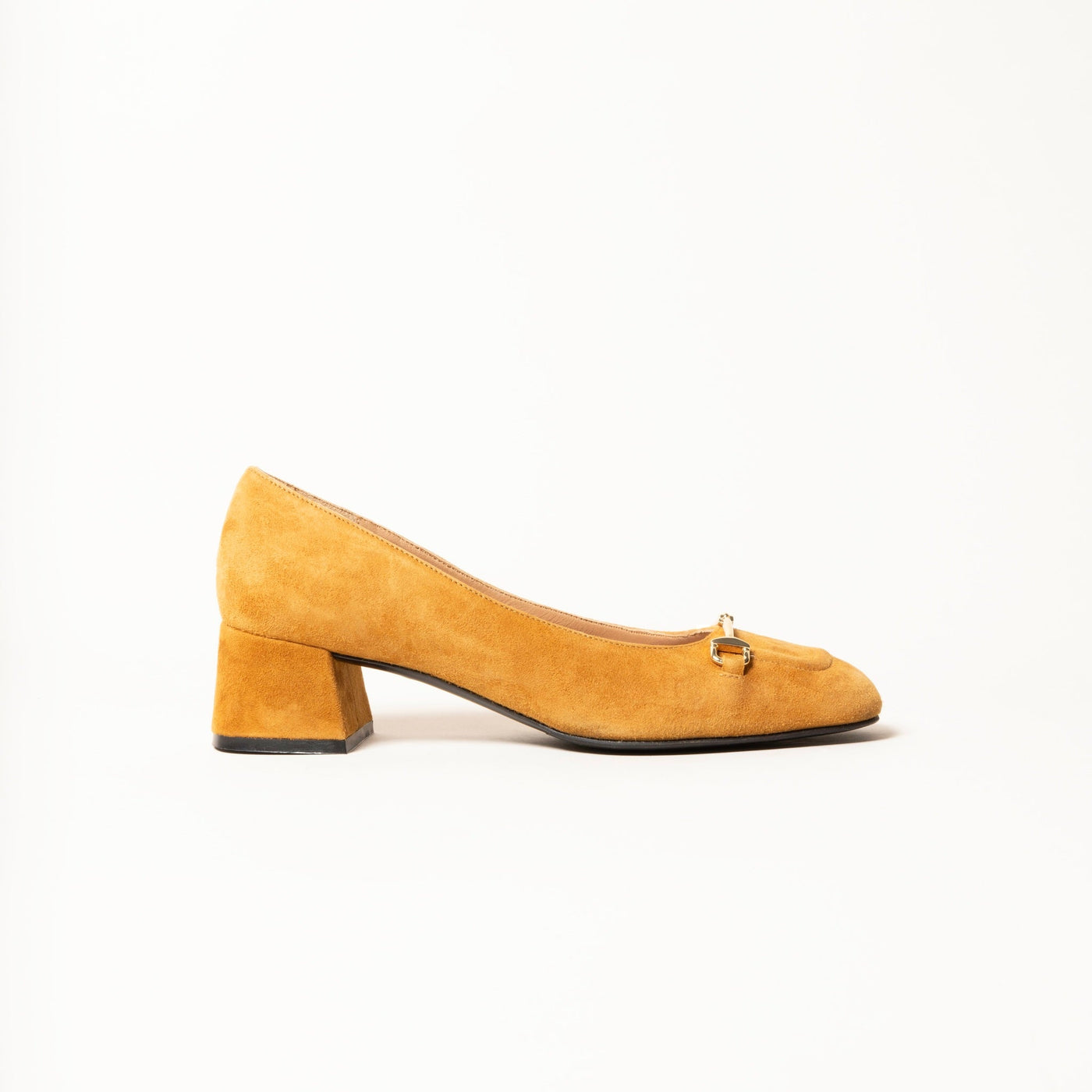 Heeled pump made from soft suede leather, featuring a square-shaped toe with a gold metallic horse-bit buckle