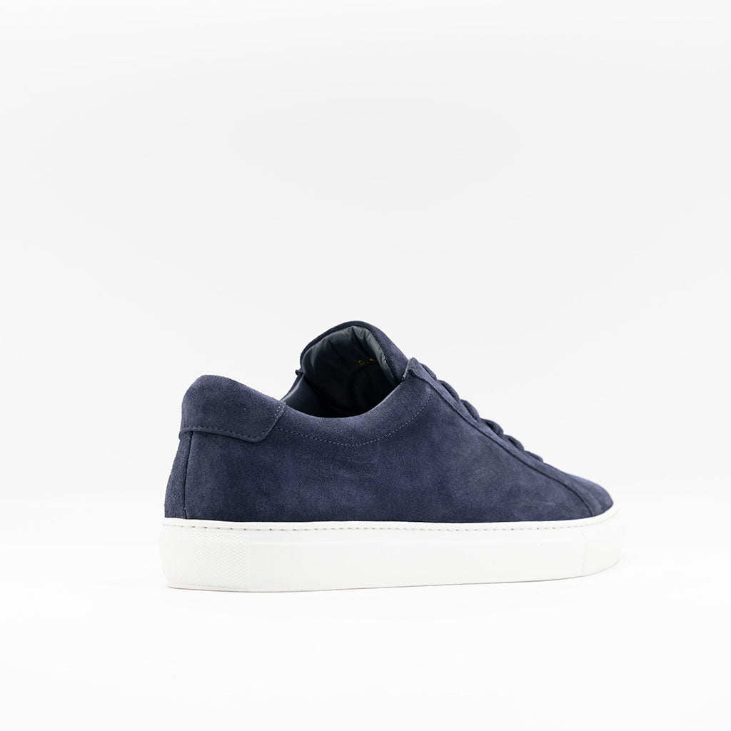 Mens classic sneaker in navy suede with white rubber sole. 