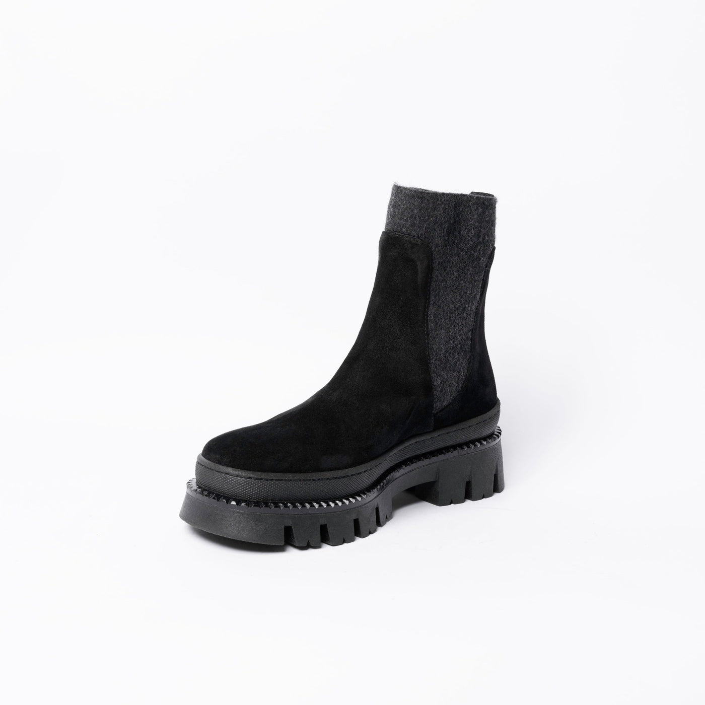 Ankle boots in black suede with chunky rubber soles. .