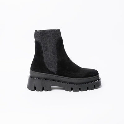 Ankle boots in black suede with chunky rubber soles. .