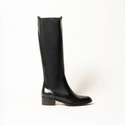 Black leather riding boot with brogue pattern. 